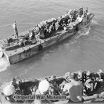 Indian troops embarking from the cruiser HMS KENYA