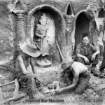 Preparing a meal beside a temple on Ramree Island