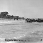 Royal Marines of HMS KENYA dashing ashore on the beach at Cheduba