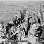 Royal Marines return to their cruiser HMS KENYA off Cheduba