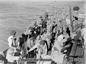 Royal Marines return to their cruiser HMS KENYA off Cheduba