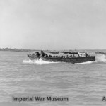 Wooden hulled assault craft with Marines on board nearing the beach at Cheduba