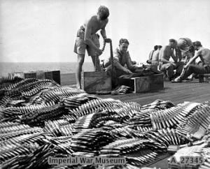 Armourers check and load ammunition for Hellcat fighters