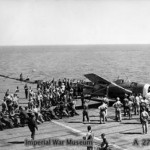 Men helping to clear a crashed Grumman Hellcat